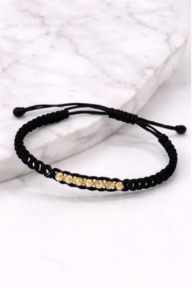 Manilla Oro · Hilo negro trenzado + bolas de oro laminado 18k